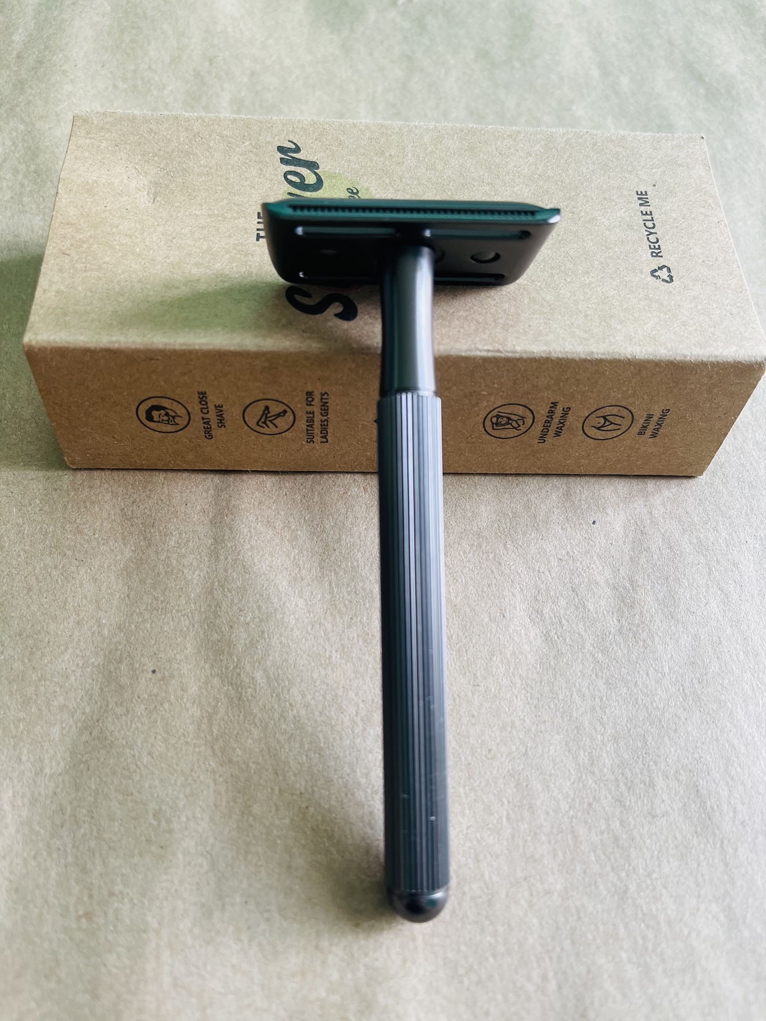 Everything Bald black safety razor on its cardboard packaging